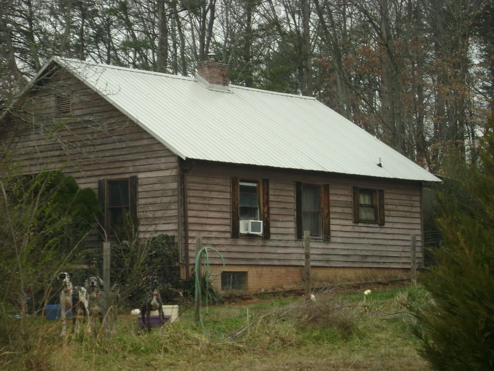 White metal roof on an old wood sided farmhouse, from a Metal Roof Installation job in La Salle